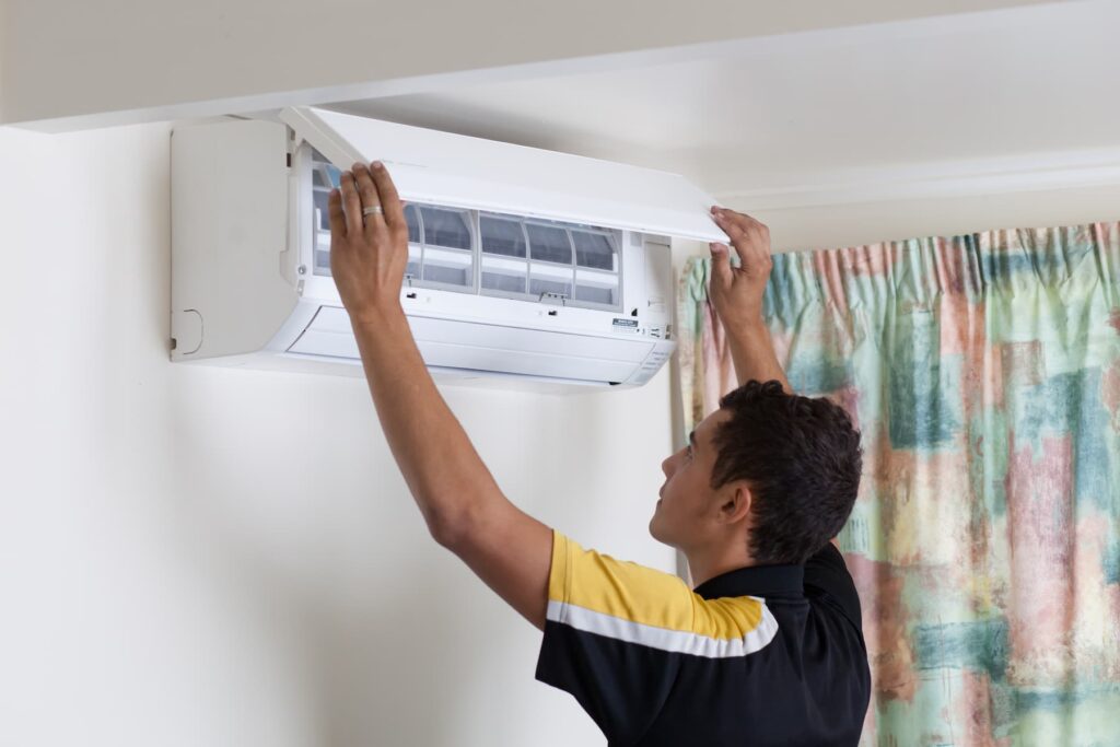 Technician checking the filter in a heat pump