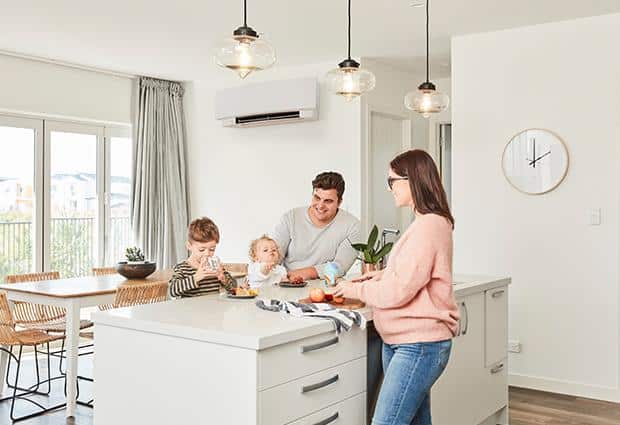 Daikin heat pump on wall with family